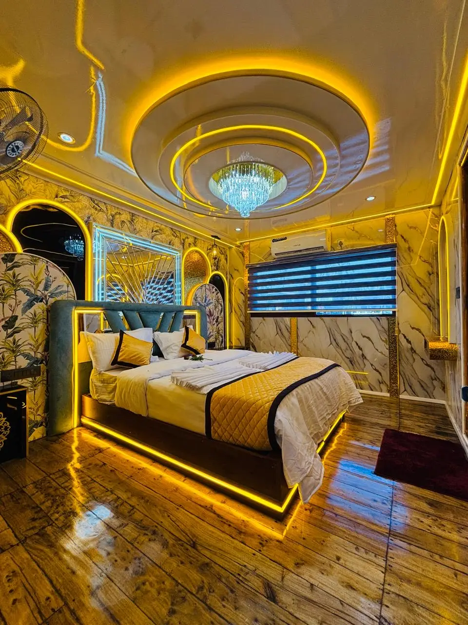 Second gold-finished bedroom with backlit bed base on a Kerala houseboat