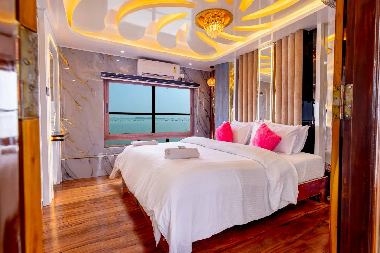 Air-conditioned houseboat bedroom with a picture window over the backwaters