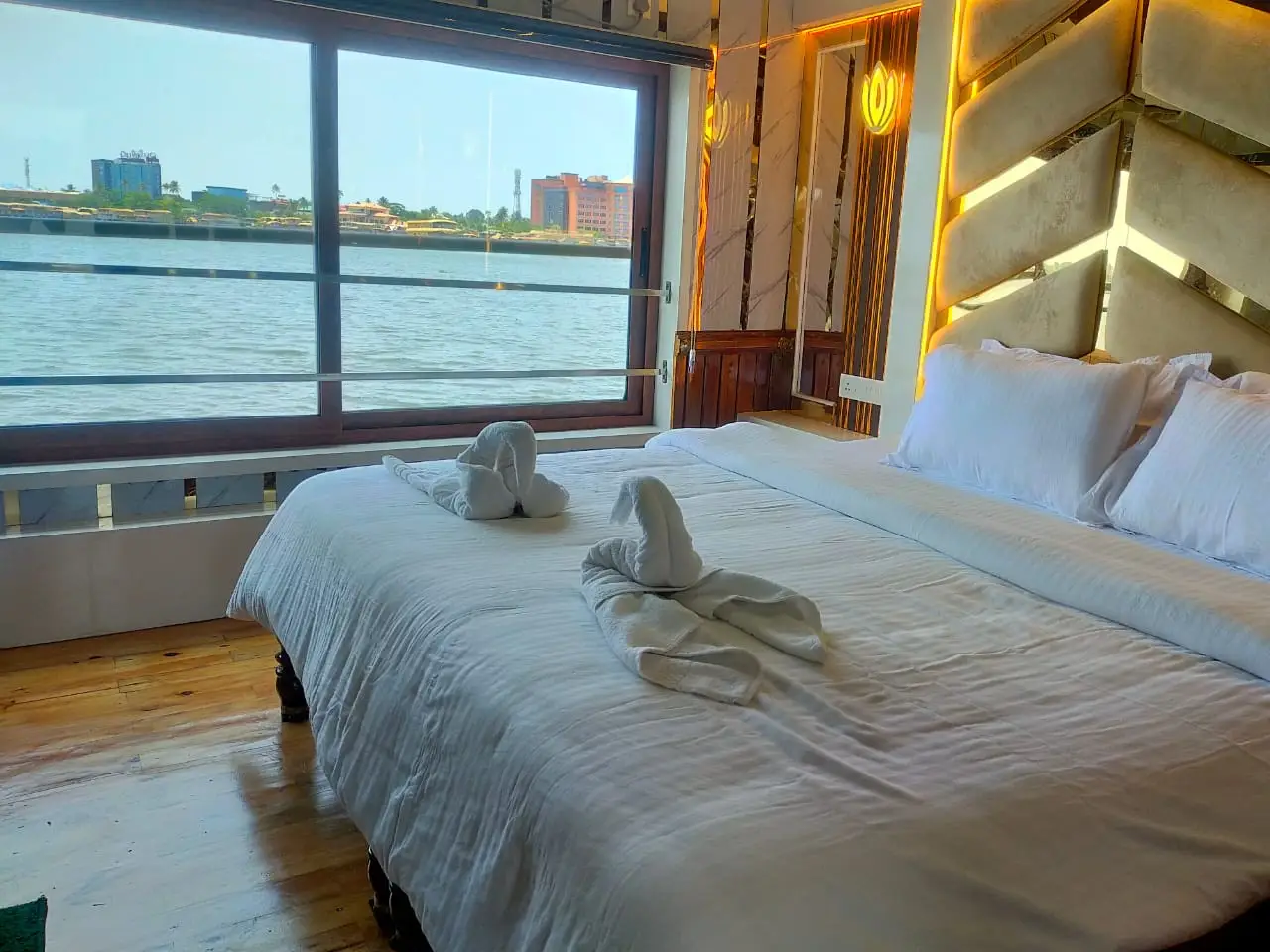 Houseboat bedroom with a full-width window looking out over Vembanad lake