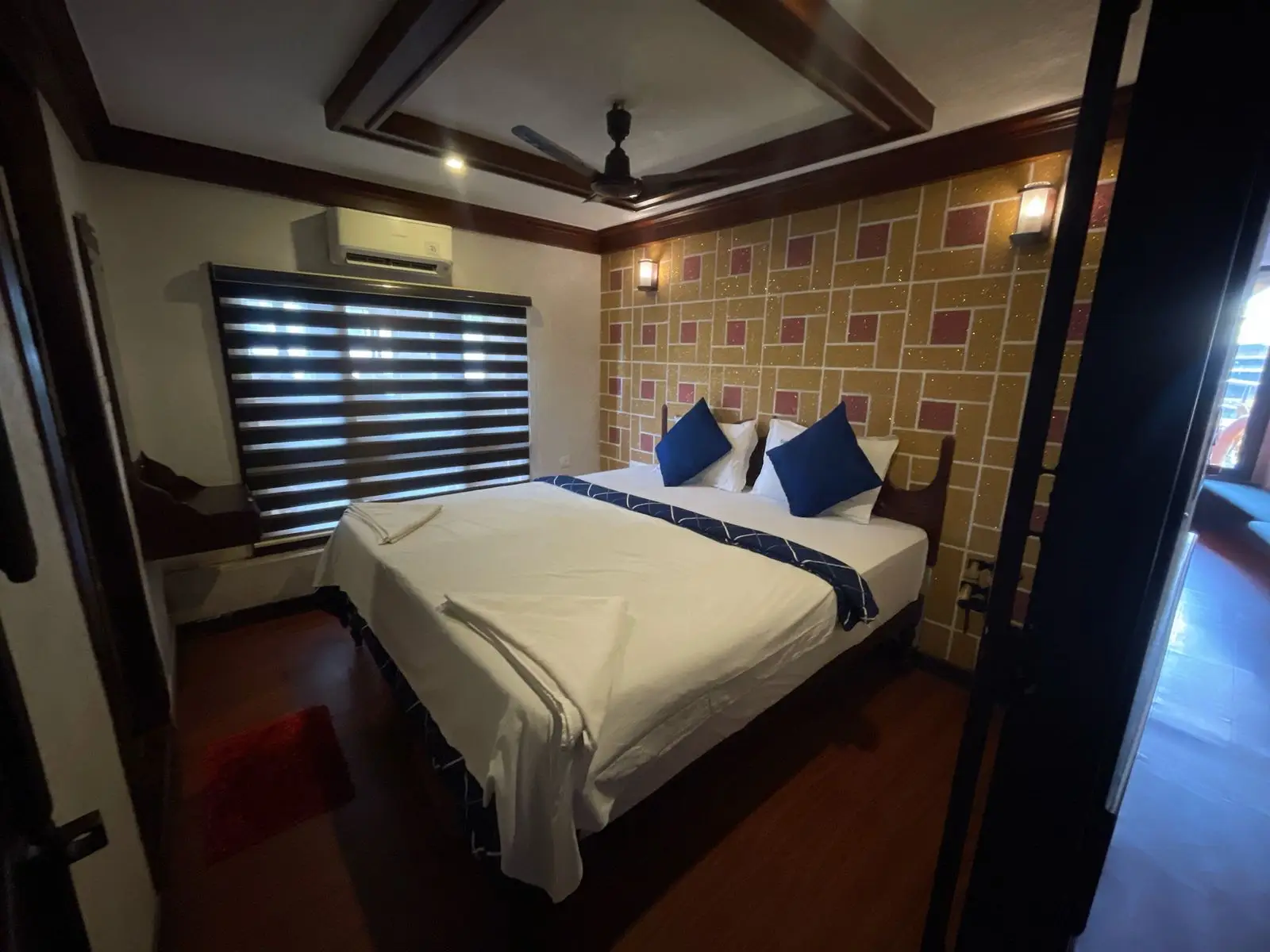 Second air-conditioned bedroom with ceiling fan and blackout blinds