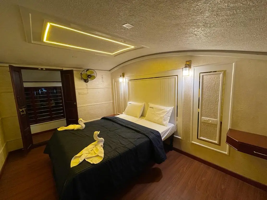 Second air-conditioned bedroom with backlit ceiling on a large Alleppey houseboat