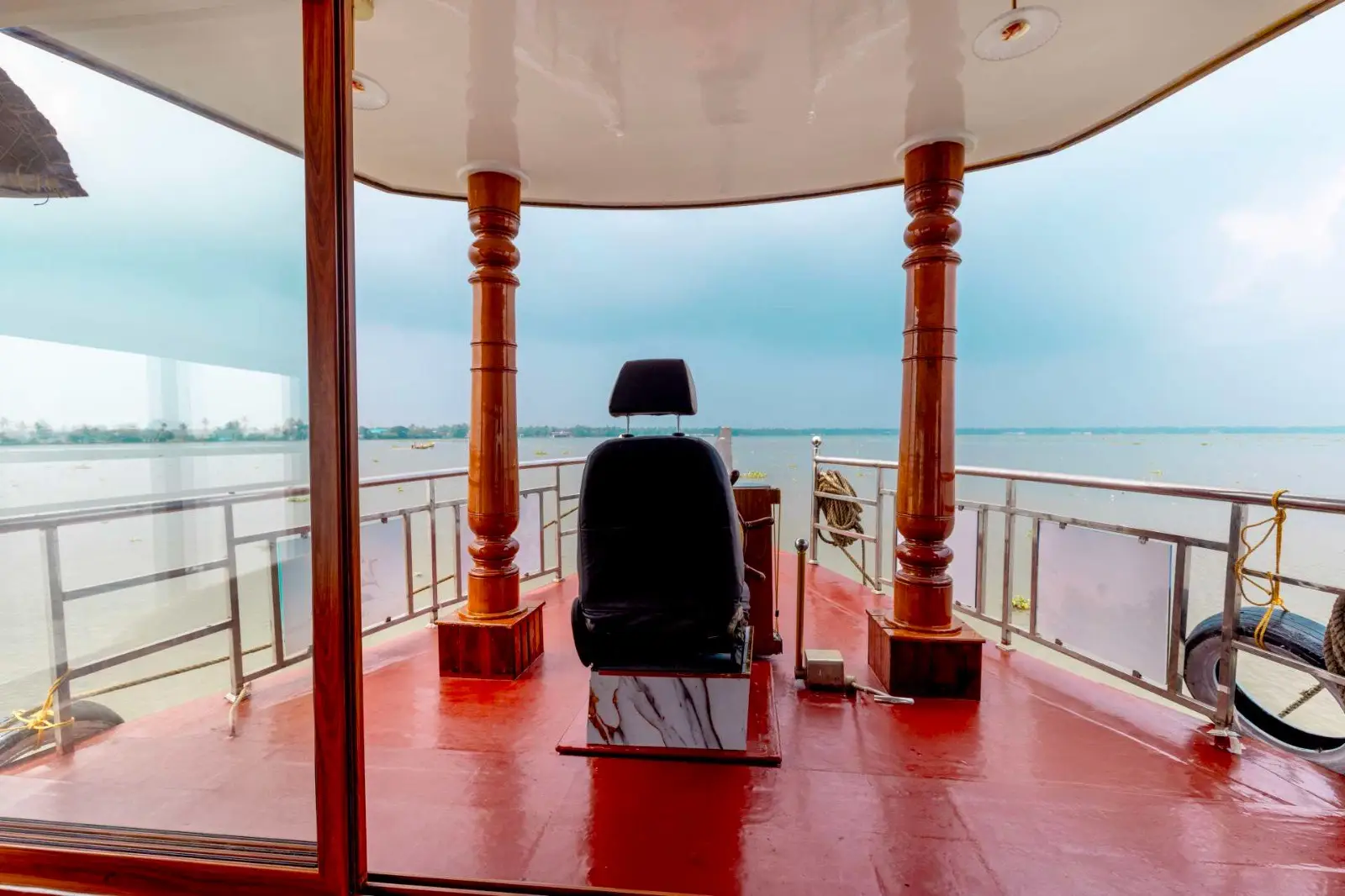 Captain's seat and wheel looking out over the open backwaters