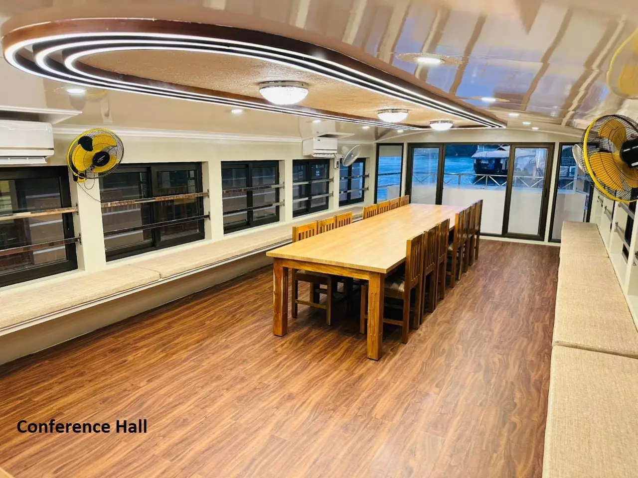 Banquet table and bench seating in the conference hall of a houseboat
