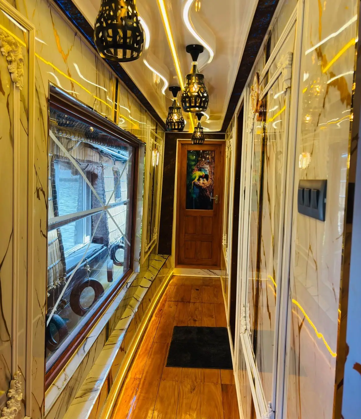 Marble-panelled corridor with hanging lanterns leading to the bedroom