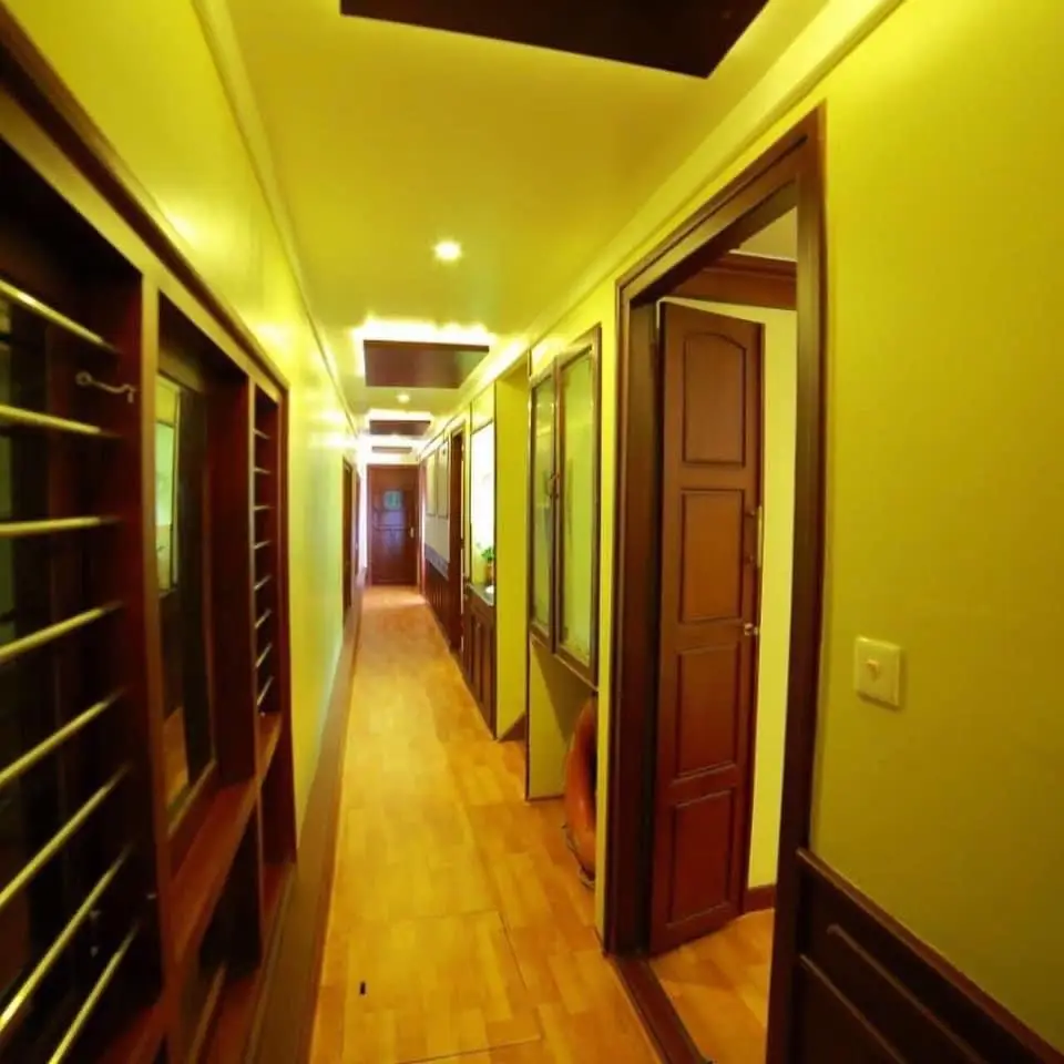 Lower deck corridor with polished wood flooring on a Kerala houseboat
