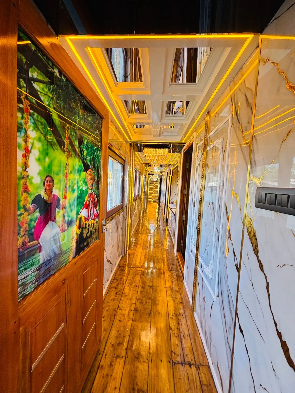 Interior corridor with Kerala mural artwork and marble panelling