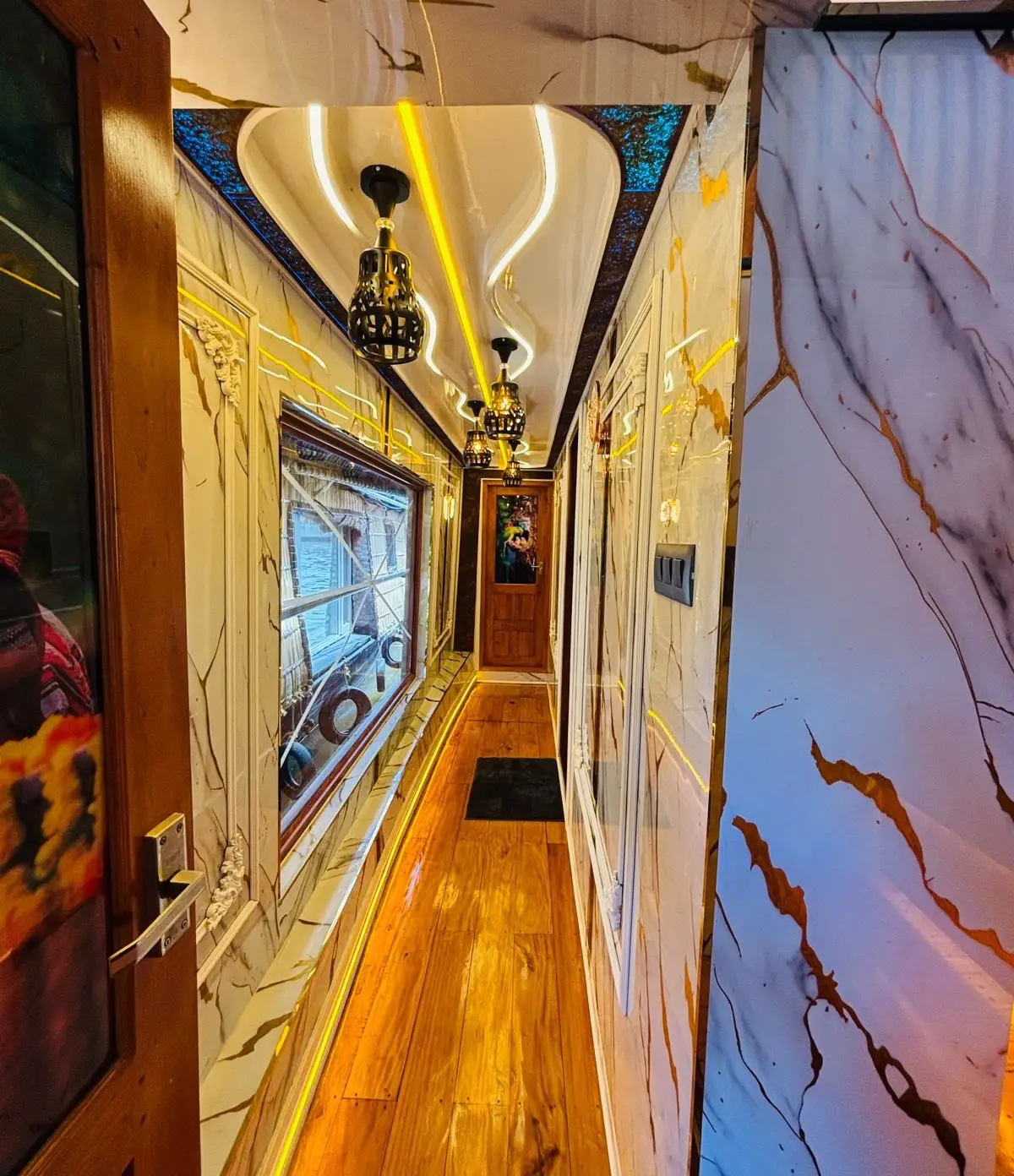 Polished wood corridor running the length of a premium Alleppey houseboat