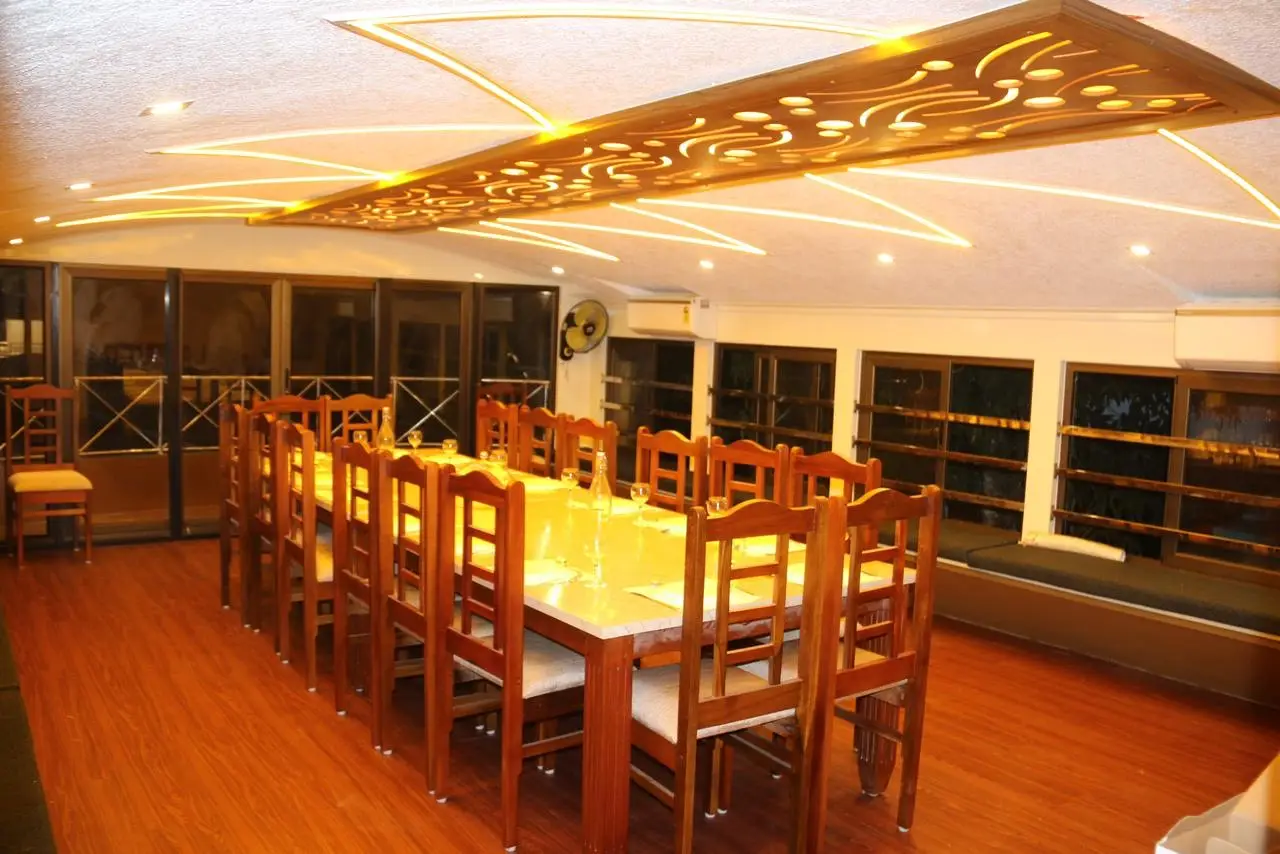 Dining hall with carved lit ceiling panel on an eight-bedroom houseboat