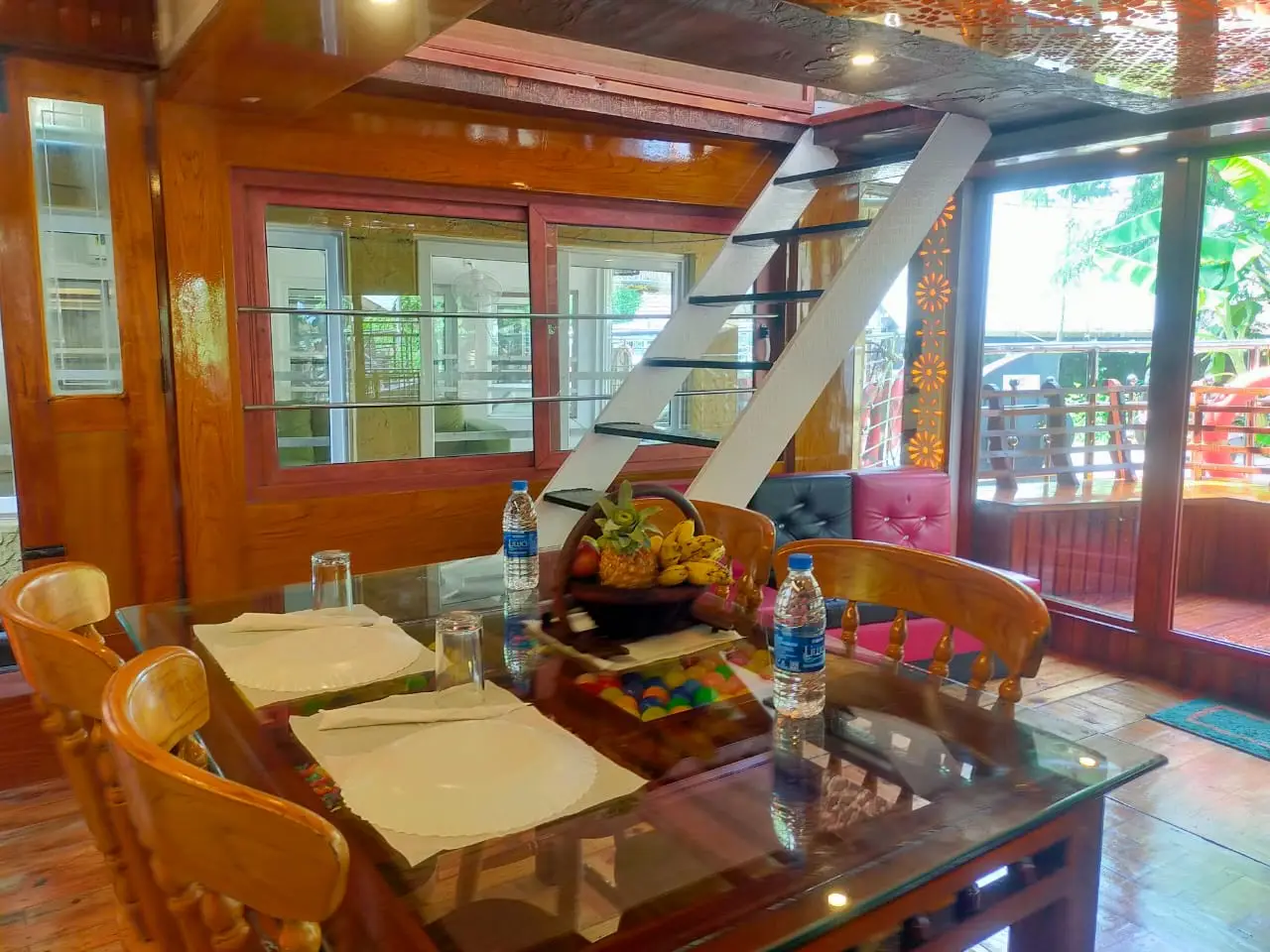 Dining table laid with a welcome fruit basket on a Kerala backwater houseboat