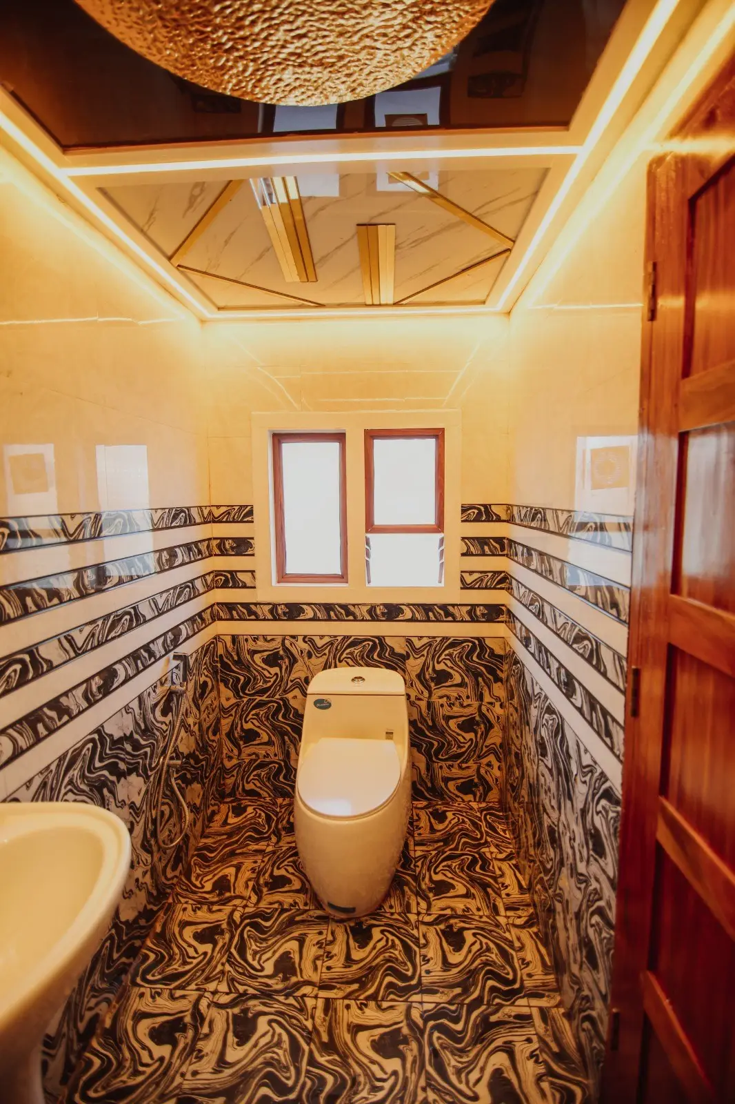 Marble en-suite bathroom with gold fittings on a luxury Kerala houseboat