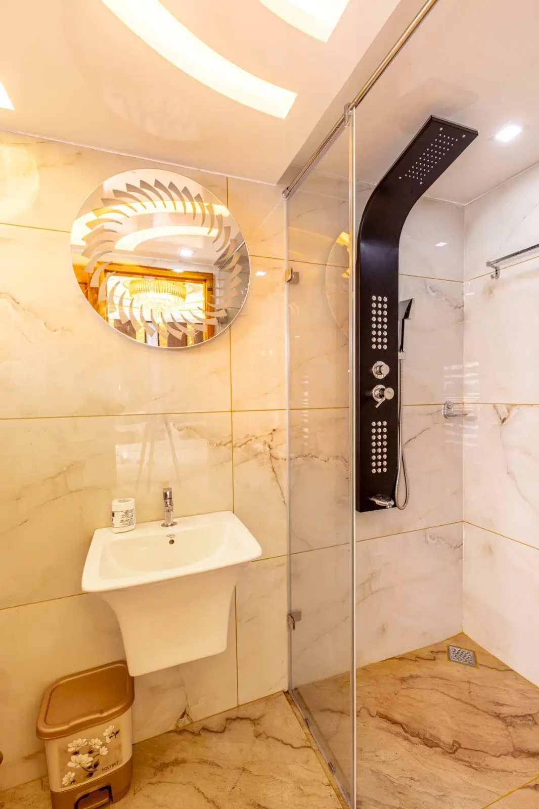 Glass rain-shower cubicle in a marble en-suite bathroom on an Alleppey houseboat