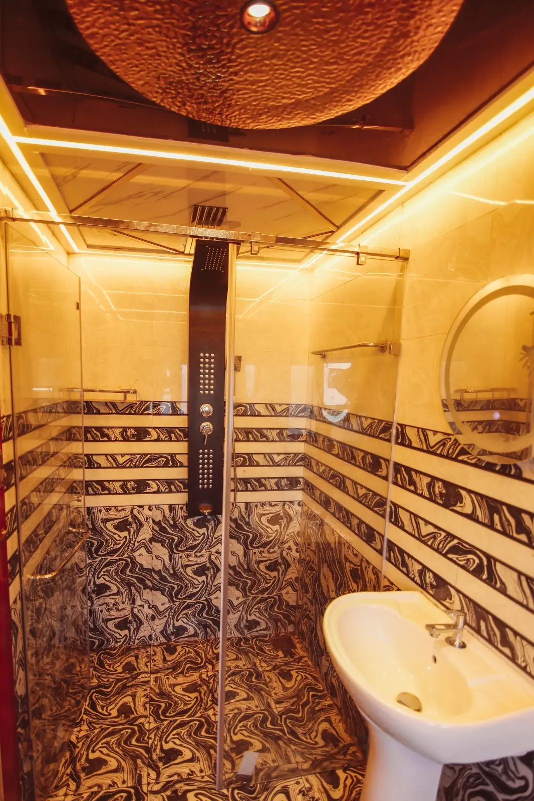 Walk-in shower cubicle with overhead panel in a luxury houseboat bathroom