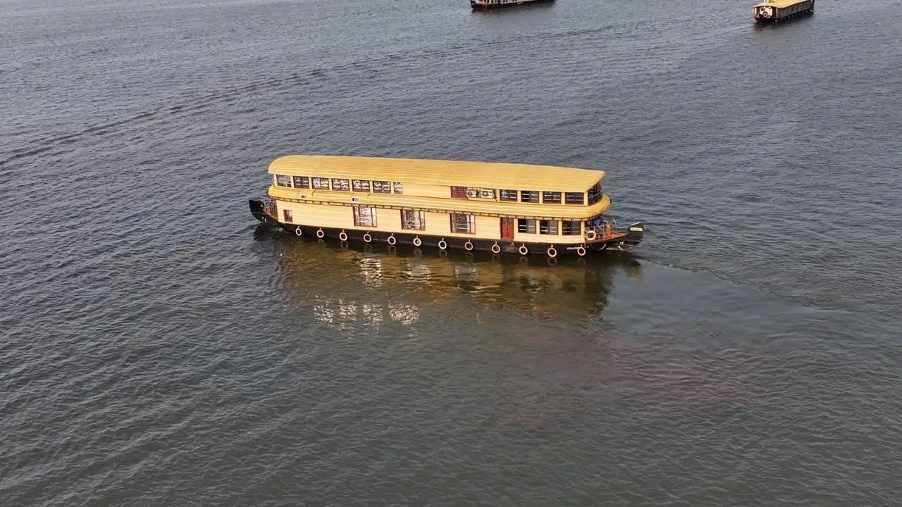 Aerial view of a large four-bedroom Kerala houseboat cruising the backwaters