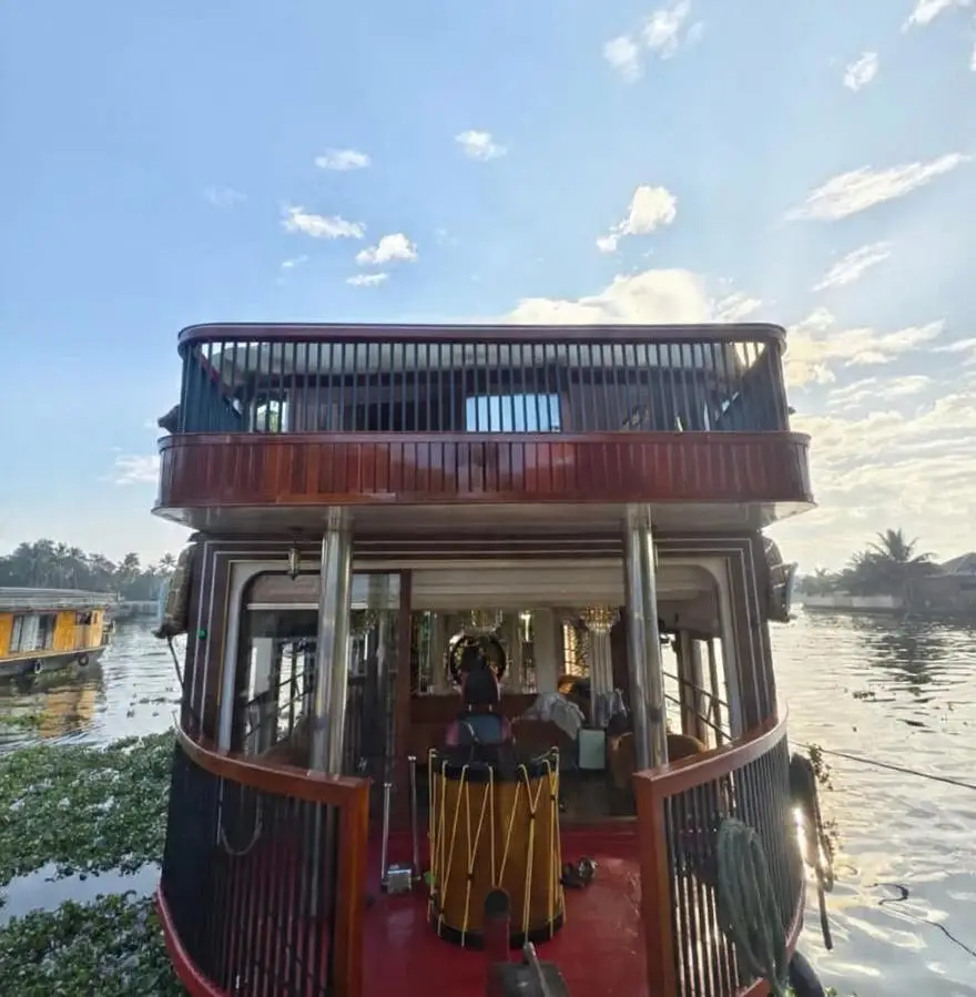 Bow and upper sundeck of a five-bedroom Kerala houseboat at sunrise