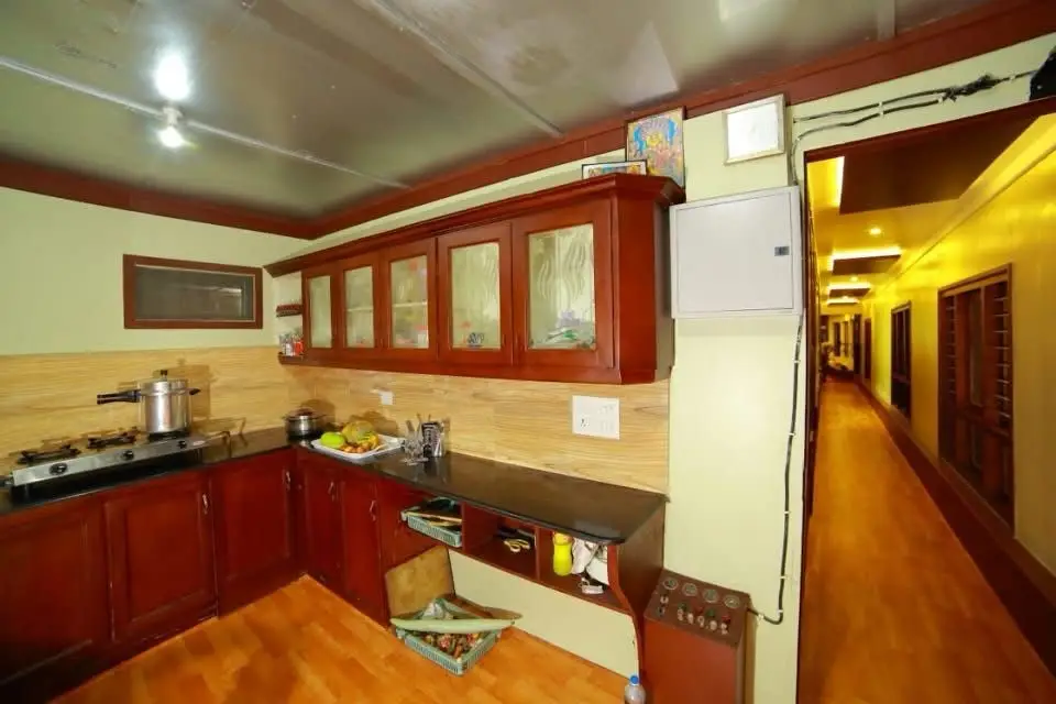 Full onboard kitchen where the crew cook fresh Kerala meals on a houseboat