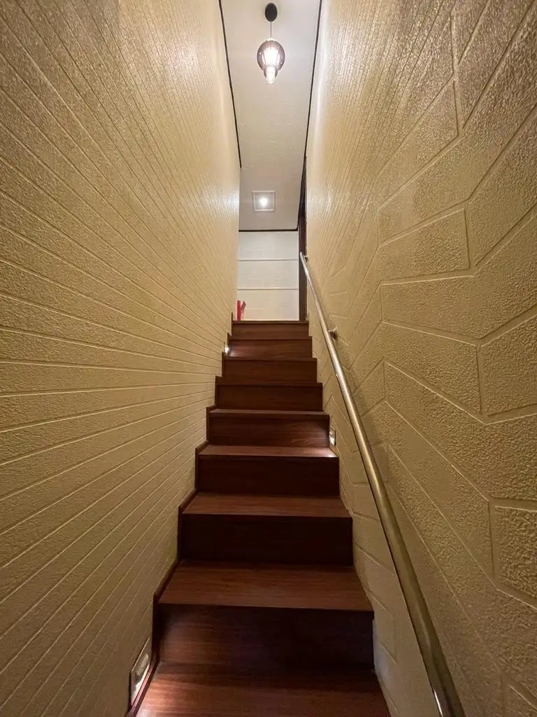 Staircase connecting the decks of an eight-bedroom Alleppey houseboat