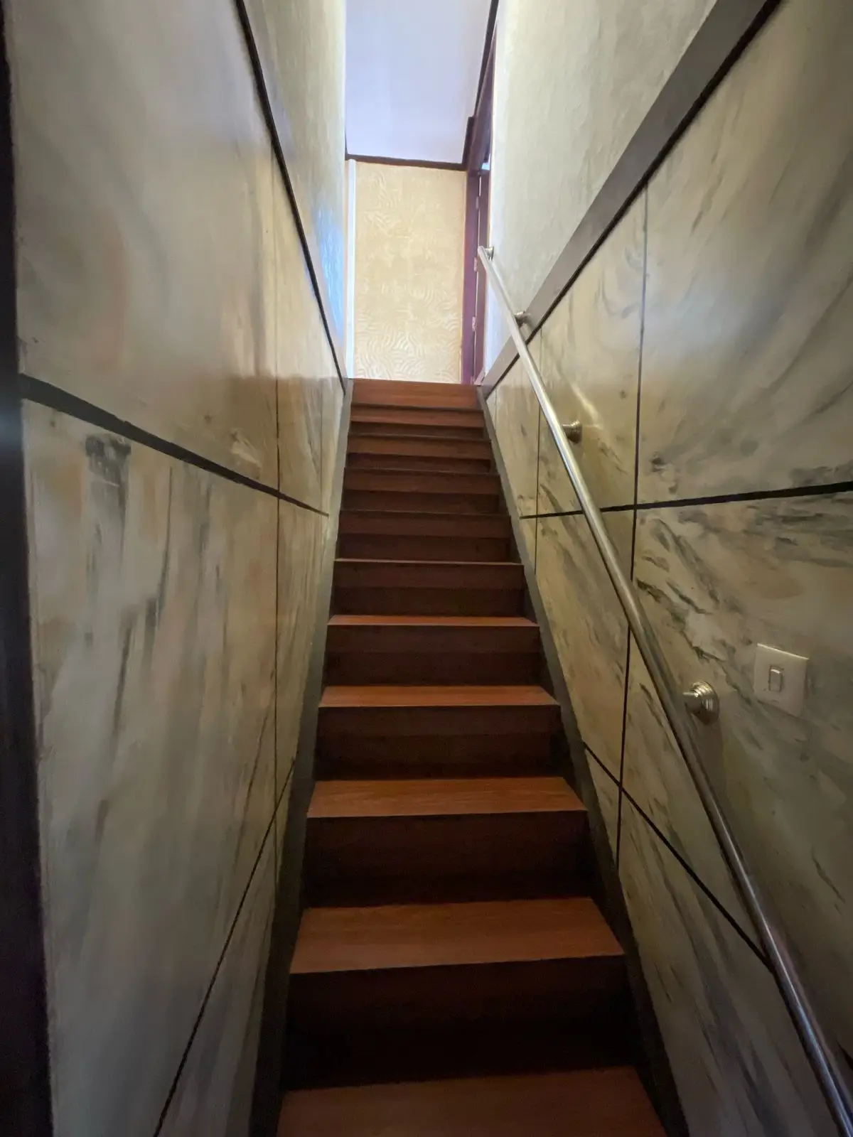 Staircase to the upper deck of a six-bedroom Alleppey houseboat