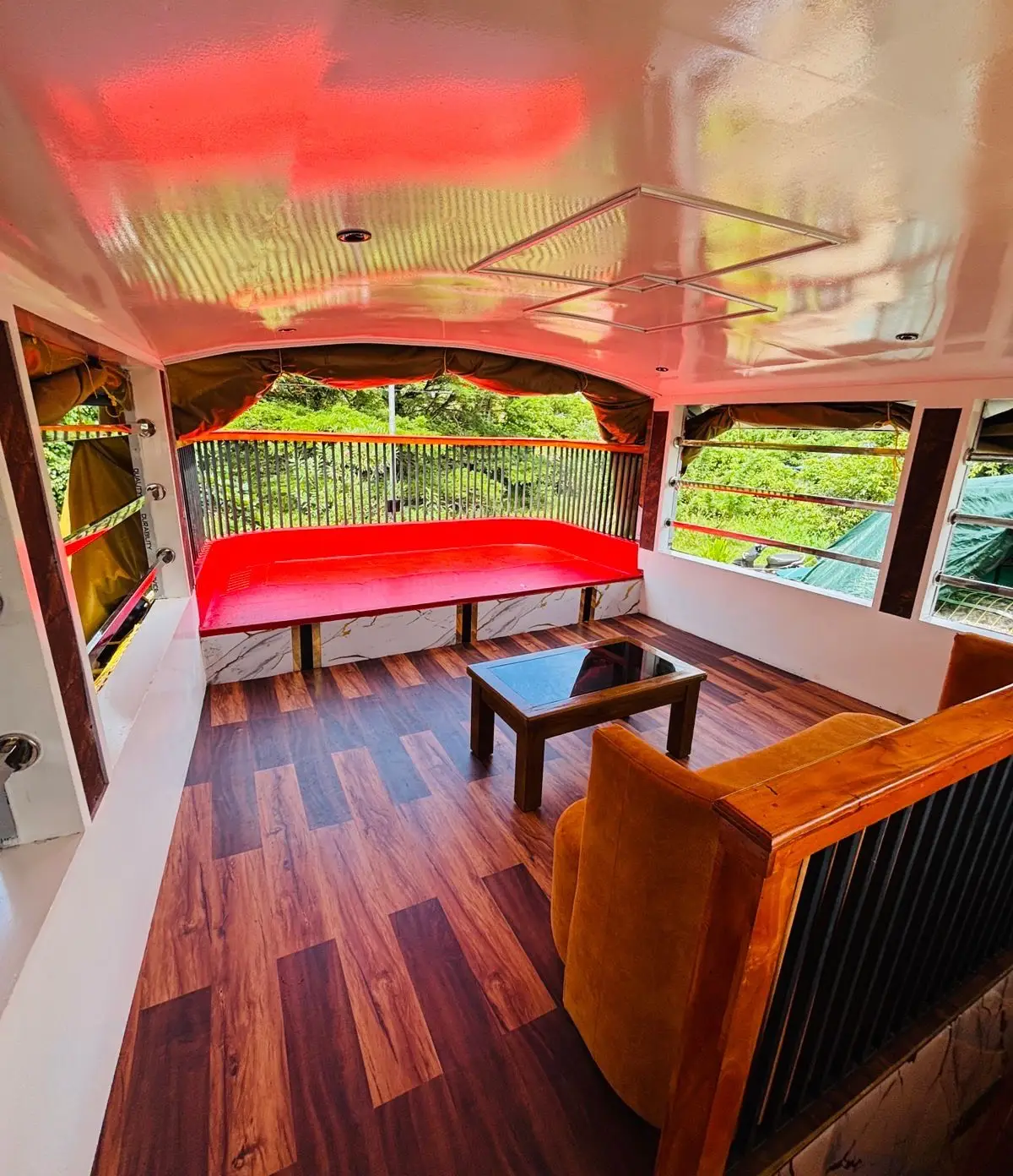 Shaded sundeck with cushioned bench seating overlooking the Alleppey canals